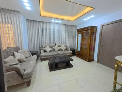 a living room with two couches and a coffee table at 220 sqm 3 BR Um Al Summag, Makka Street