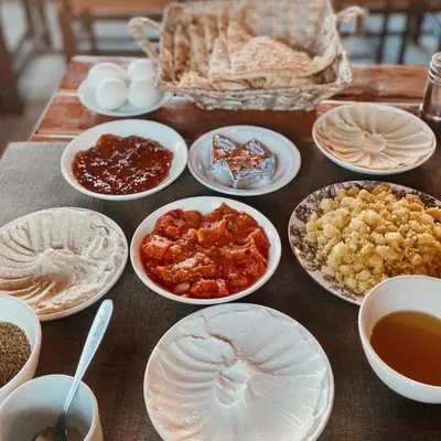 a table with plates and bowls of food on it at Dana Trail Nomad Camp in Dana