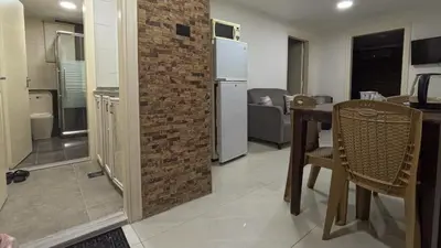 a kitchen and dining room with a brick wall at Masaya Al Deyar Apartments in Amman