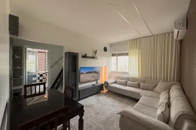 a living room with a couch and a tv at Modern Loft Studio Panoramic Views And Smart Design in Amman