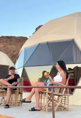 a group of people sitting in chairs in front of a tent at Wadi Rum Ahmad comp in Wadi Rum