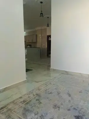 an empty room with a kitchen and a floor at شقق العون in Jerash