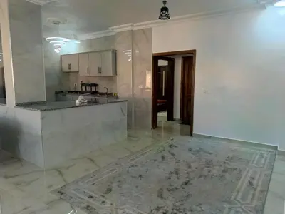 an empty kitchen with a counter in a room at شقق العون in Jerash