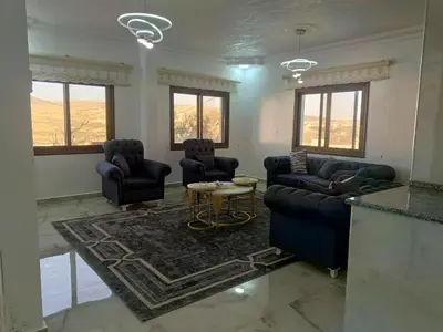 a living room with couches and a table at شقق العون in Jerash