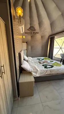 a small bedroom with a bed in a room at MAYA RUM LUXURY CAMP & Jeep Tours in Disah