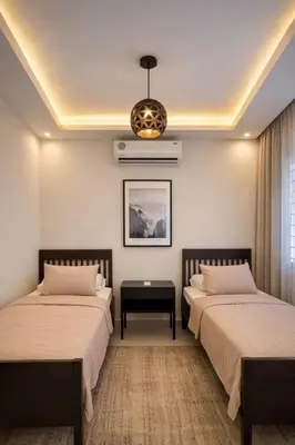 a bedroom with two beds and a chandelier at Der Ghbar 3BR - 2 Terraces, Scenic Views & BBQ in Amman