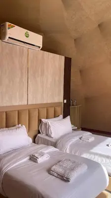 two beds sitting next to each other in a room at Red Moon Camp in Wadi Rum