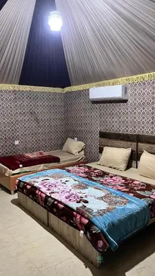 a bedroom with two beds in a room at Red Moon Camp in Wadi Rum