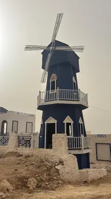 a blue windmill sitting on top of a building at Santorini Resort & Spa in Sowayma