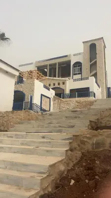 a large building with stairs in front of it at Santorini Resort & Spa in Sowayma
