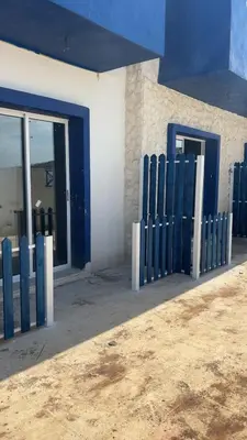 a building with blue and white doors and windows at Santorini Resort & Spa in Sowayma