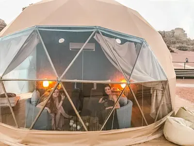 a group of people sitting inside of a tent at Rina Luxury Camp in Disah