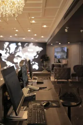 an office with a desk with a laptop and a keyboard at Nishan Hotel in Amman