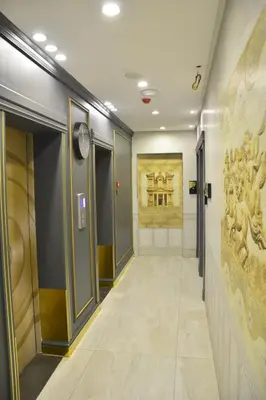 a hallway in a building with a painting on the wall at Nishan Hotel in Amman