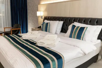 a bedroom with a large bed with towels on it at Nishan Hotel in Amman