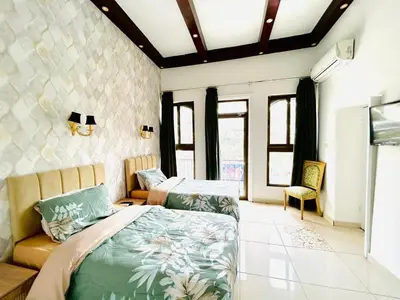 a bedroom with two beds and a couch at Zaman Ya Zaman Boutique Hotel in Amman