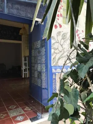 a room with a blue door and a tile floor at Zaman Ya Zaman Boutique Hotel in Amman