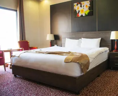 a hotel room with a large bed in a room at Olive Hotel Amman in Amman