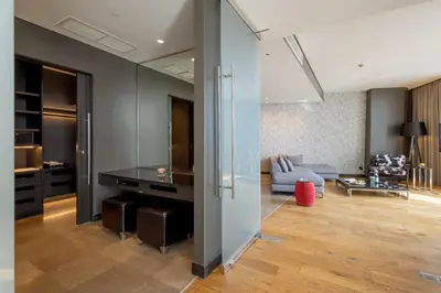 a living room with a large glass wall at Amman Rotana in Amman