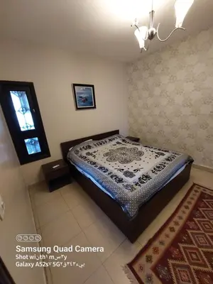 a bedroom with a bed in a room at Thara Real Estate in Sowayma