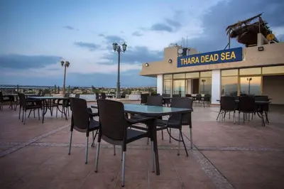 a group of tables and chairs on a patio at Thara Real Estate in Sowayma