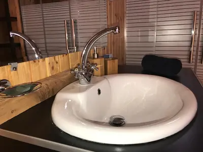 a white sink in a bathroom with a counter at Wadi Rum Camp in Wadi Rum
