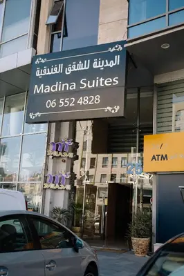 a sign for a madina suites on a building at Madina Suites in Amman
