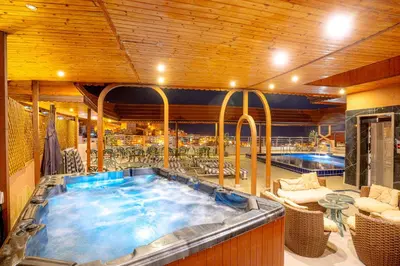 a large hot tub in a room with tables and chairs at P Quattro Relax Hotel in Wadi Musa