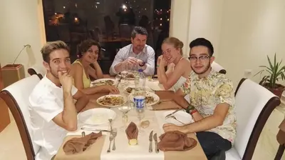 a group of people sitting around a table at P Quattro Relax Hotel in Wadi Musa