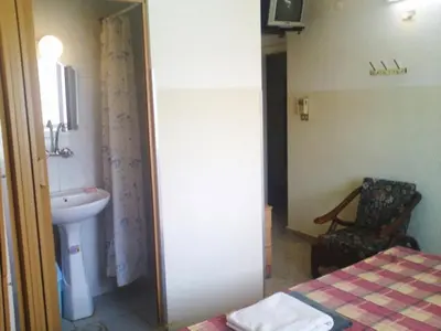 a bathroom with a sink and a toilet and a bed at Farah Hotel in Amman