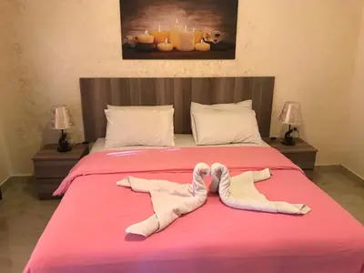 a bed with two pairs of mittens and socks on it at Suzan Hotel Apartments in Amman