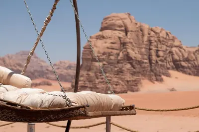 a swing in the desert with a rock formation at Rum Stars Camp in Wadi Rum