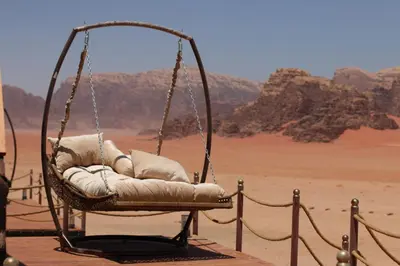 a hanging chair in the middle of the desert at Rum Stars Camp in Wadi Rum