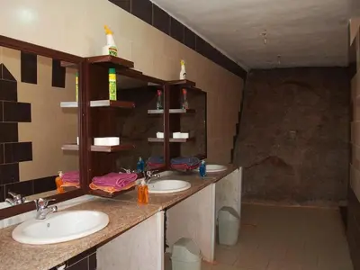 a bathroom with two sinks and a mirror at Bedouin Traditions Camp in Wadi Rum