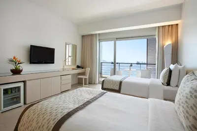 a hotel room with two beds and a television at Kempinski Hotel Aqaba in Aqaba