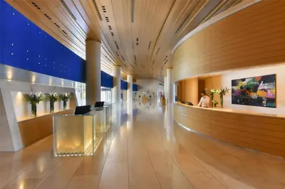 a lobby of a building with a long hallway at Kempinski Hotel Aqaba in Aqaba