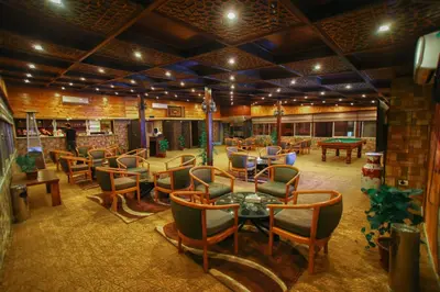 a room with chairs and tables and ping pong balls at La Maison Hotel in Wadi Musa