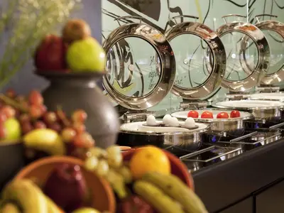 a bunch of pots and pans on a stove with fruit at ibis Amman in Amman