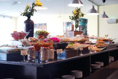 a buffet line with many different types of food at MENA Tyche Hotel Amman in Amman