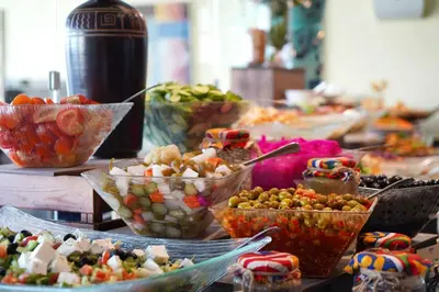 a buffet of different types of food on a table at MENA Tyche Hotel Amman in Amman
