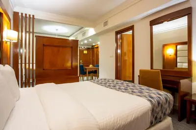 a hotel room with a bed and a desk at Sadeen Amman Hotel in Amman