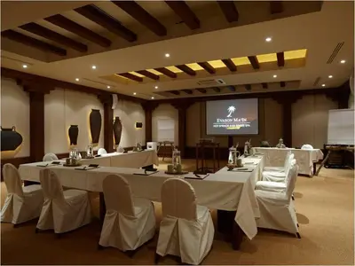 a conference room with white tables and chairs and a screen at Ma'in Hot Springs in Sowayma