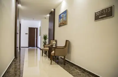 a hallway with a waiting room with a table and chairs at Sulaf Luxury Hotel in Amman
