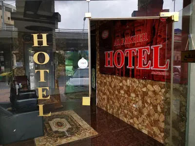 a store window with a sign for a hotel at Al Fakher Hotel Apartments & Suites in Amman
