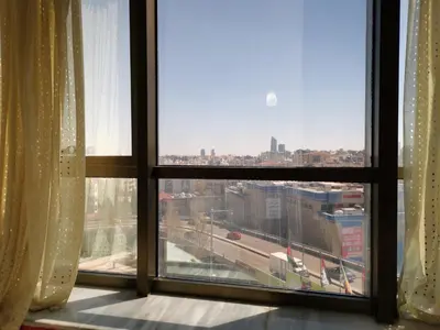 a window with a view of a city at Al Fakher Hotel Apartments & Suites in Amman