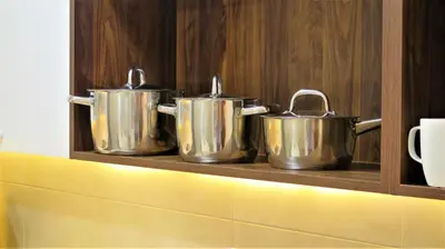 three metal pots on a shelf in a kitchen at Double Key by HR in Amman