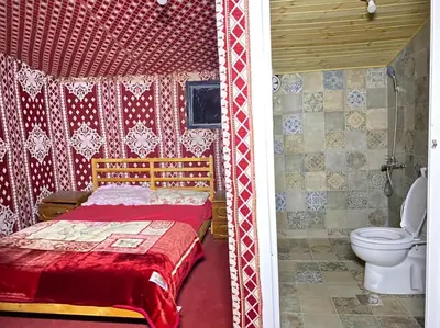 a bedroom with a bed and a toilet in a room at Bedouin life Camp in Wadi Rum