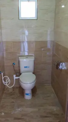 a bathroom with a toilet and a window at Bedouin life Camp in Wadi Rum