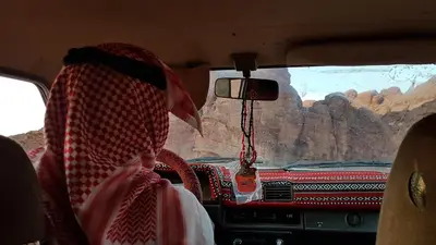a person sitting in the back of a bus looking out the window at Jordan Tracks Bedouin Camp in Wadi Rum