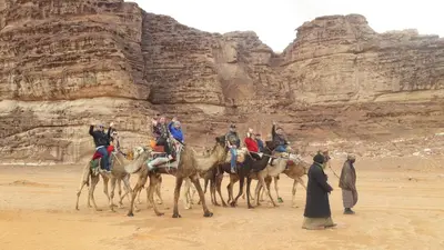 a group of people riding on horses in the desert at Wadi Rum Desert Secret in Wadi Rum